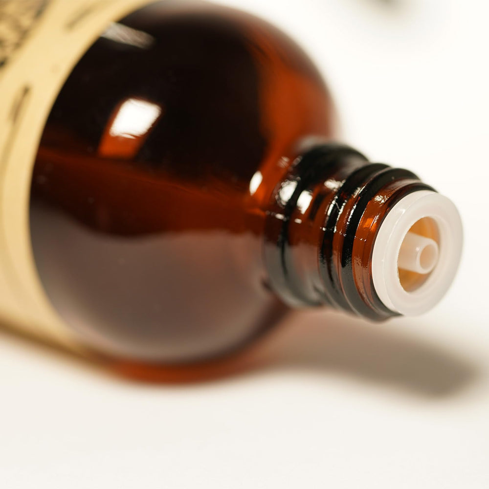 Dark amber glass bottle of AKARZ Perilla oil