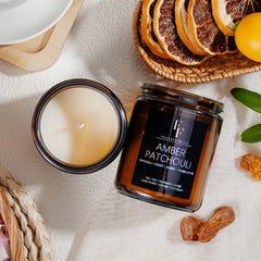 Warm candle glow illuminating a cozy room with amber jar candle