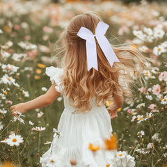 White bows enhance uniforms and boost team spirit on game day.