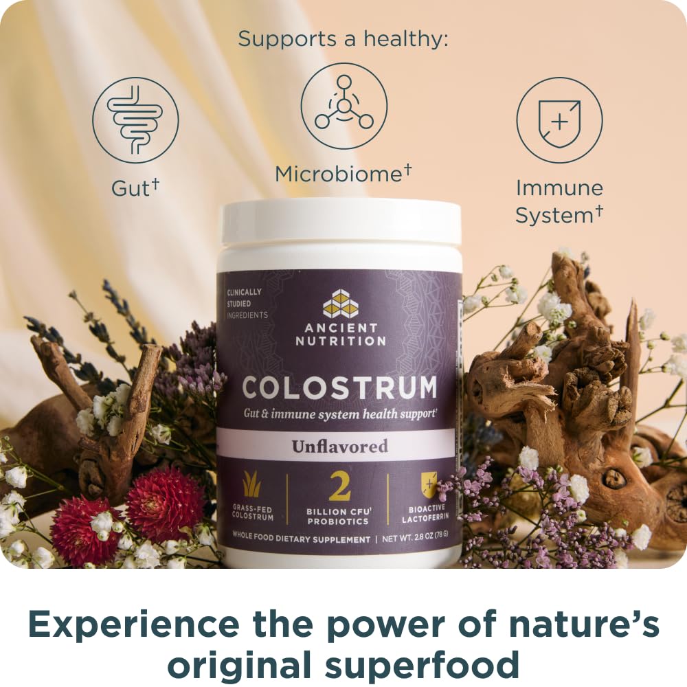 Scoop of unflavored colostrum powder being added to glass of water
