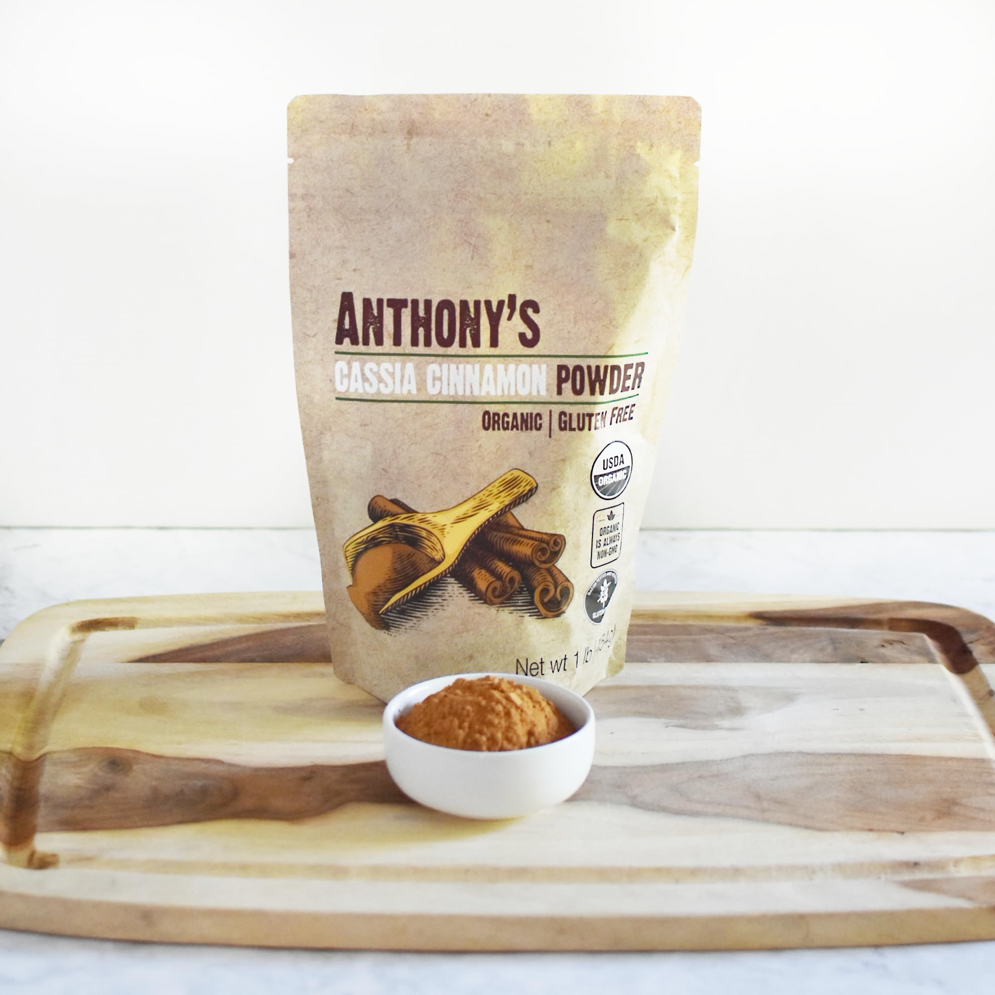 Cinnamon powder in a scoop for recipe prep