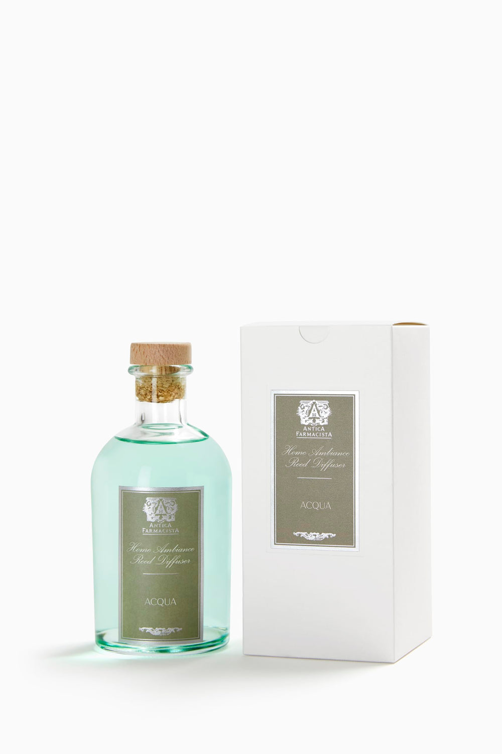 Close-up of Antica Farmacista Acqua reed diffuser in a glass bottle with reeds