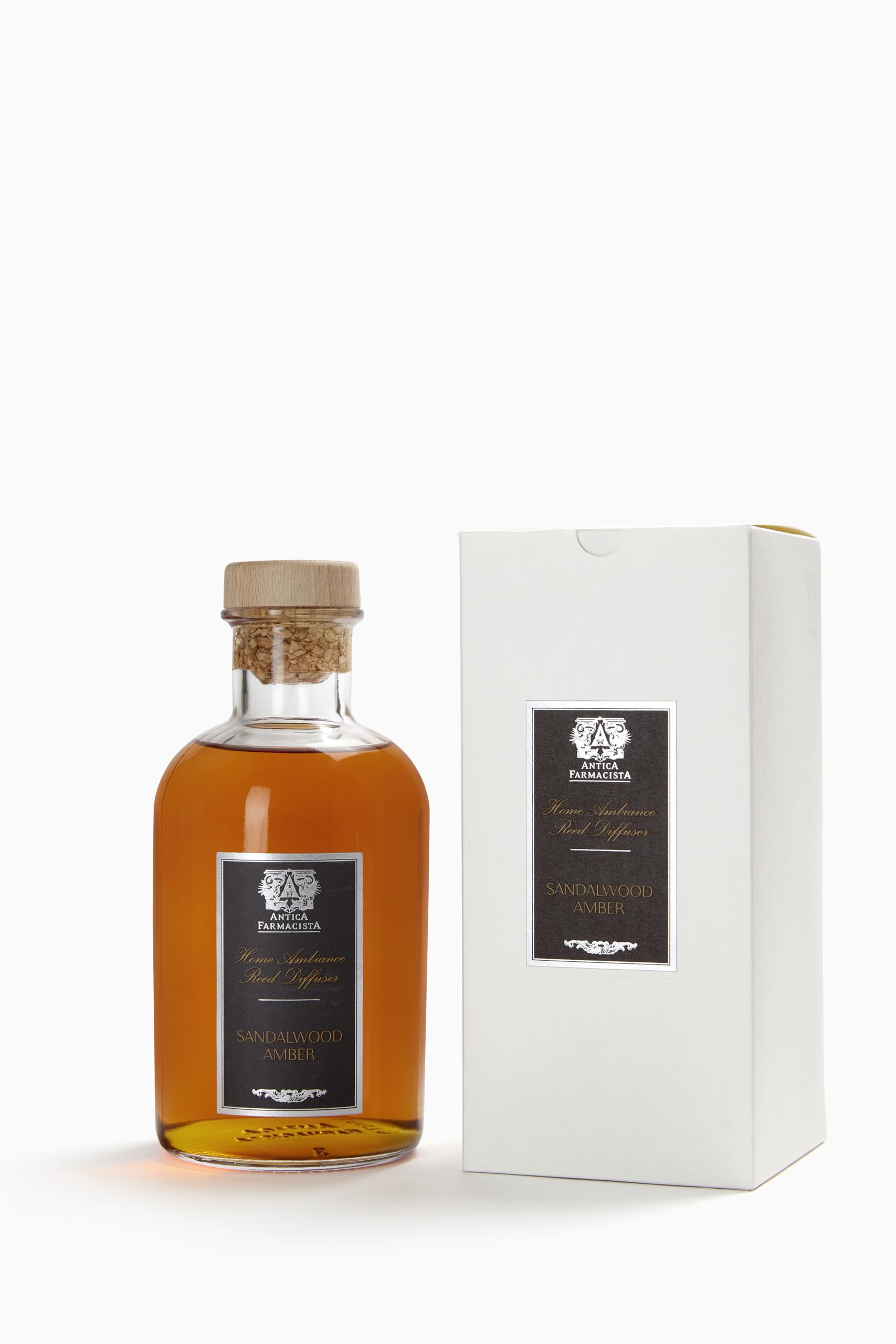 Close-up of Antica Farmacista diffuser reeds and bottle showing sandalwood amber notes
