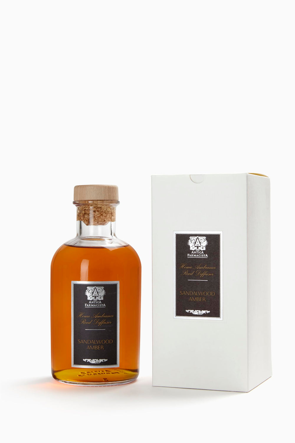 Close-up of Antica Farmacista diffuser reeds and bottle showing sandalwood amber notes