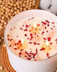 Candle topped with dried rose petals and gold foil