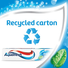 Aquafresh toothpaste beside a glass of water