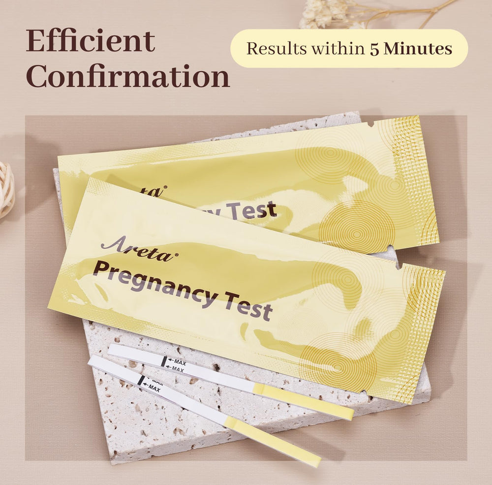 Close-up of Areta hCG test strip showing two lines (pregnant)