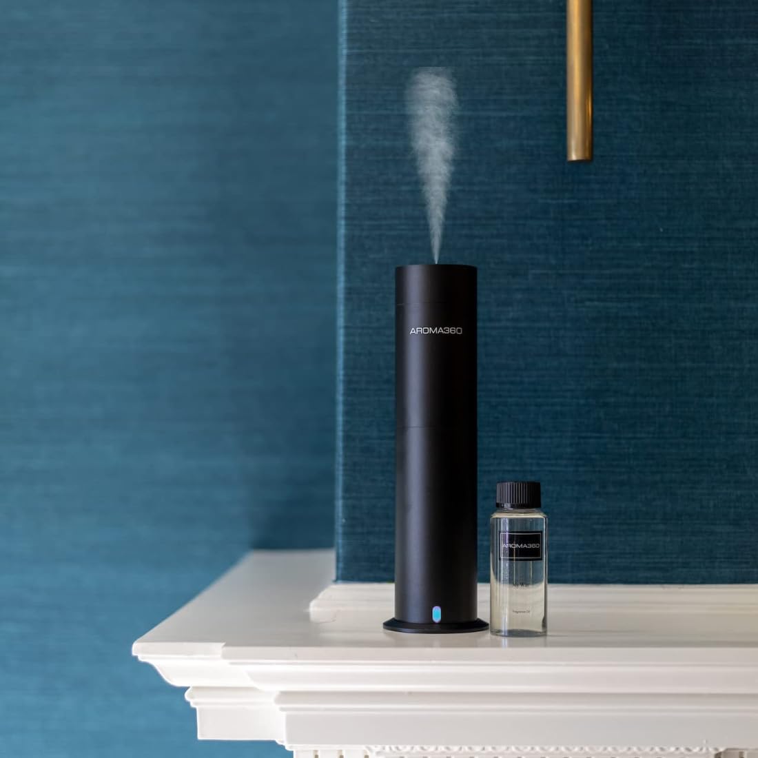 A lifestyle room setting featuring Aroma360 Adore 50mL