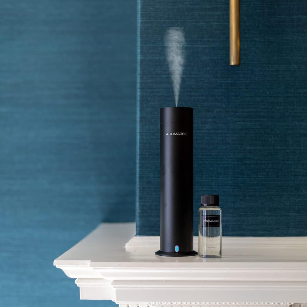 A lifestyle room setting featuring Aroma360 Adore 50mL