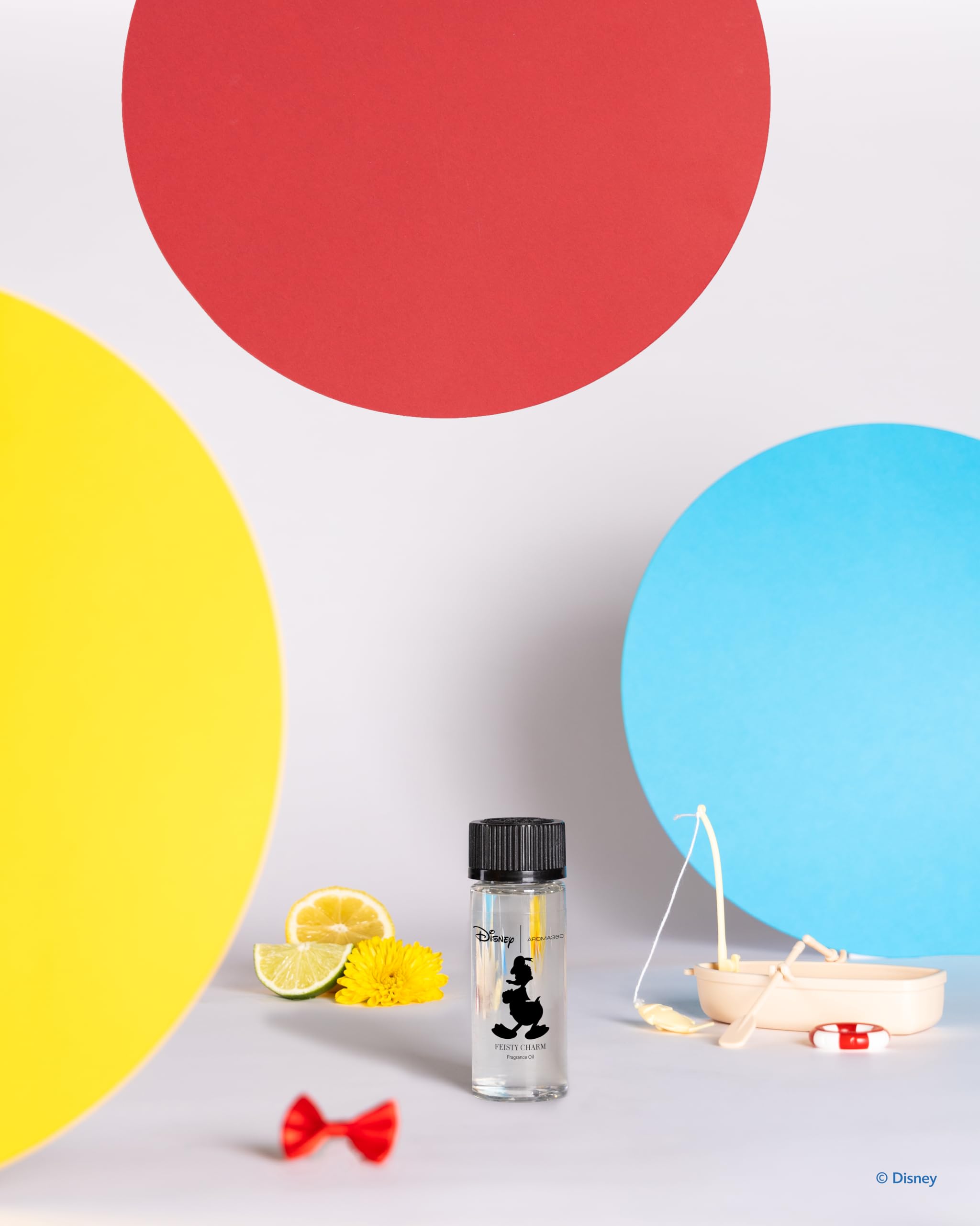 Close-up of Feisty Charm diffuser oil bottle with luxury packaging