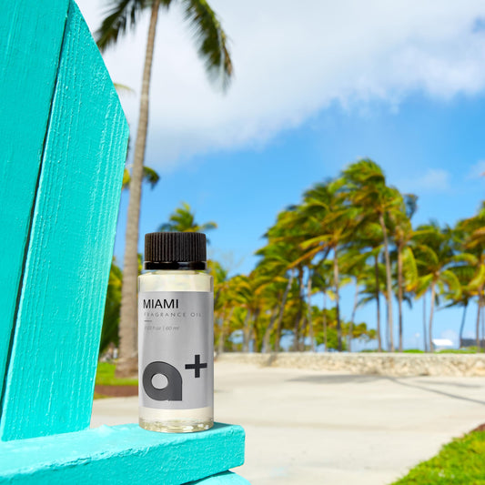 Close-up of Aromar+ Miami-inspired fragrance oil bottle with ocean breeze and lemon floral notes.