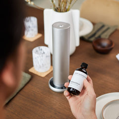 500ml AromaTech aroma oil bottle beside a diffuser