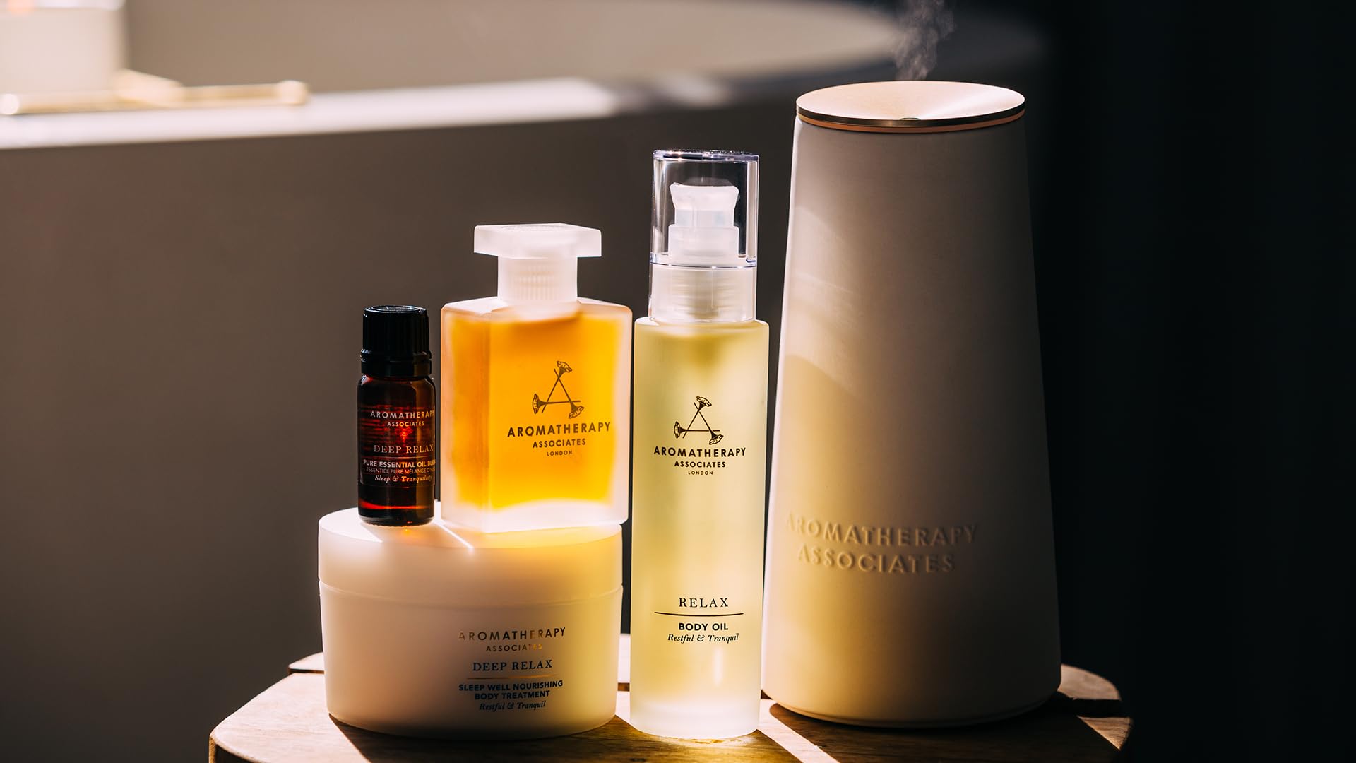 Soft-lit bedroom with Deep Relax bottle by the bed