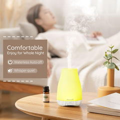 Diffuser placed in a cozy bedroom setup with soft ambient light
