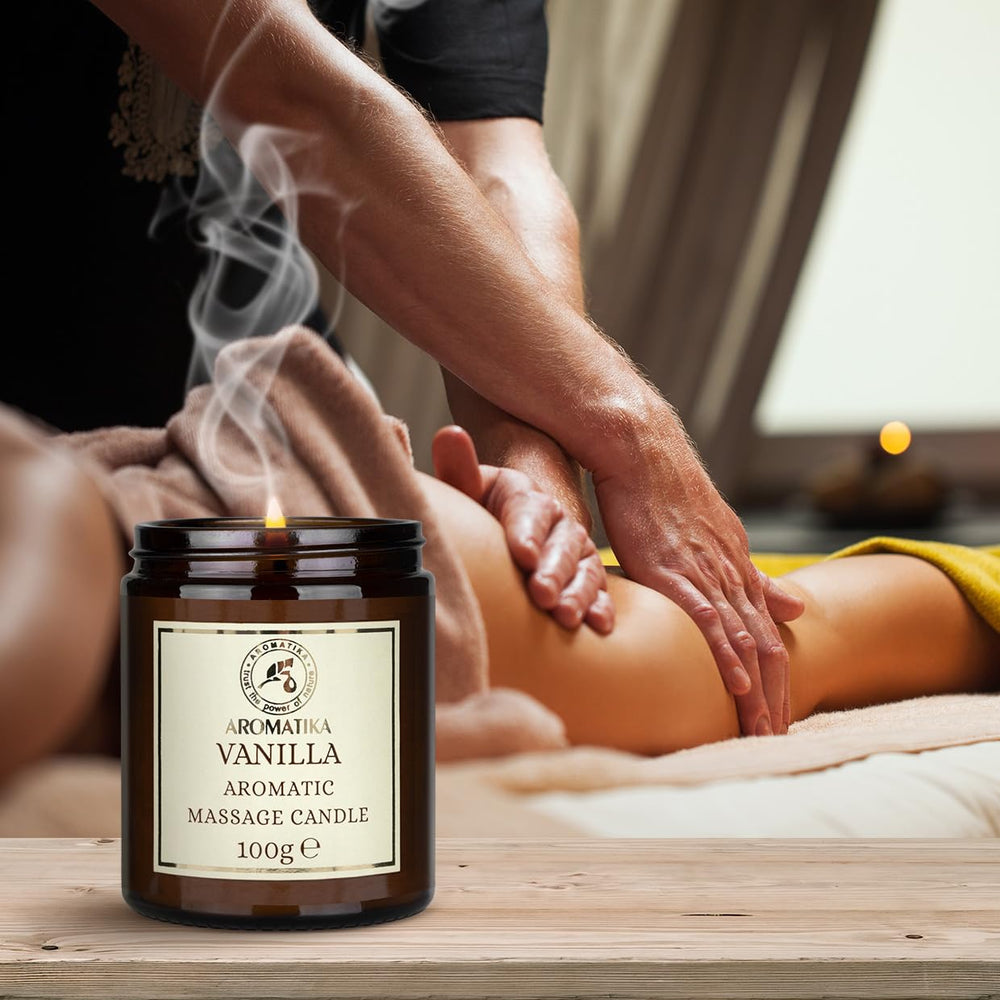 AROMATIKA Scented Massage Candle Vanilla sits in a cozy setting, ideal for gifting on birthdays or holidays.