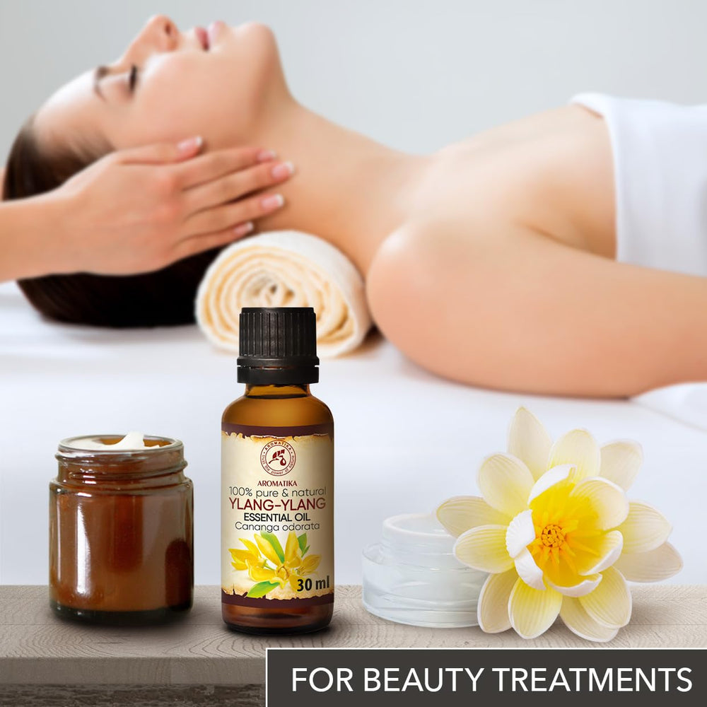 AROMATIKA Ylang Ylang oil used in a massage setup for relaxation.