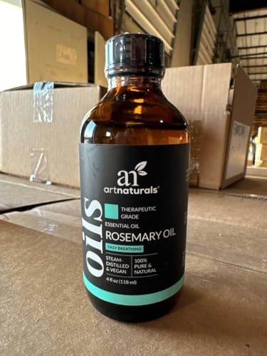 Droplet dispensing rosemary essential oil from bottle