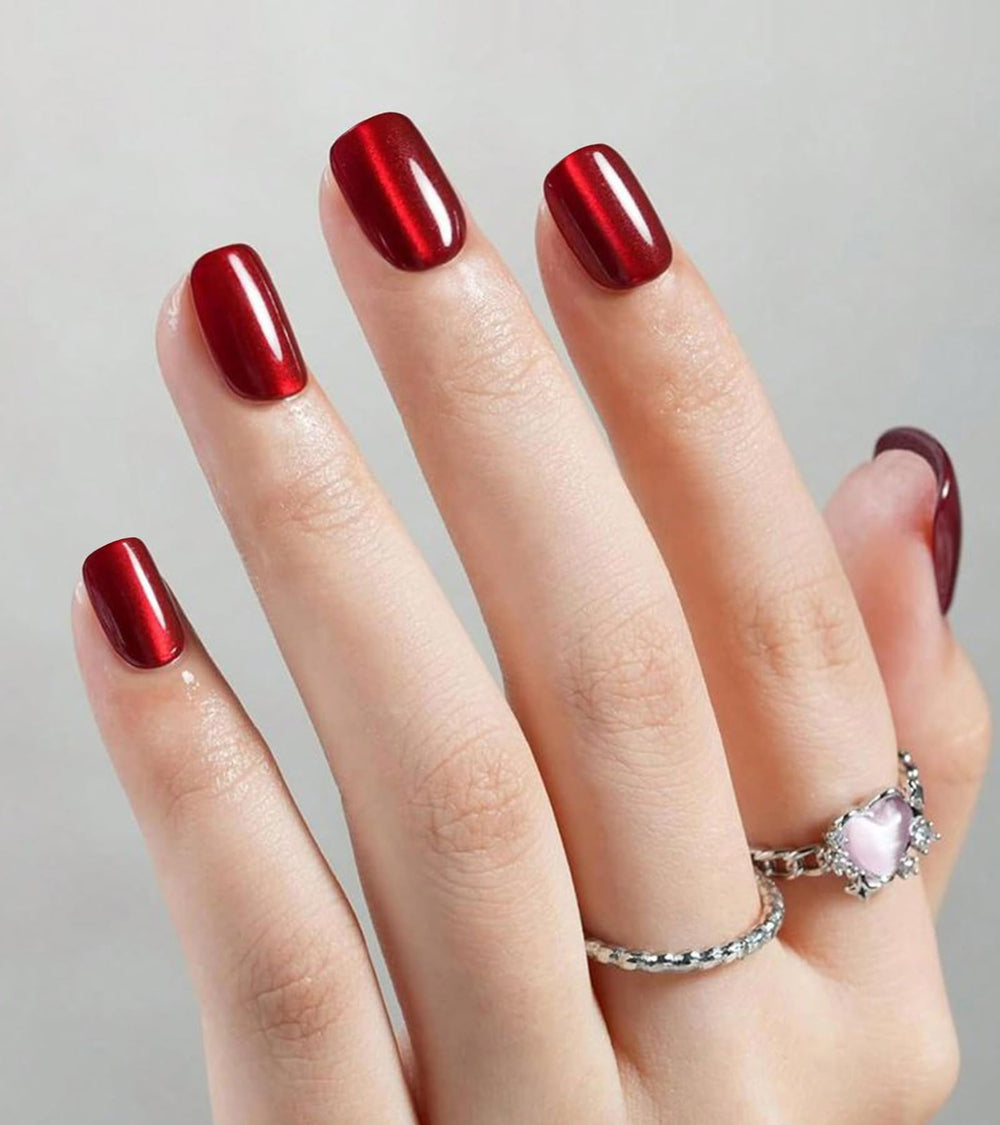 Artquee red cat eye nails with glossy finish for a salon-like look at home.