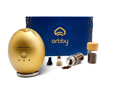 Artronic Orbby gold desk diffuser on a workspace for focused ambiance.