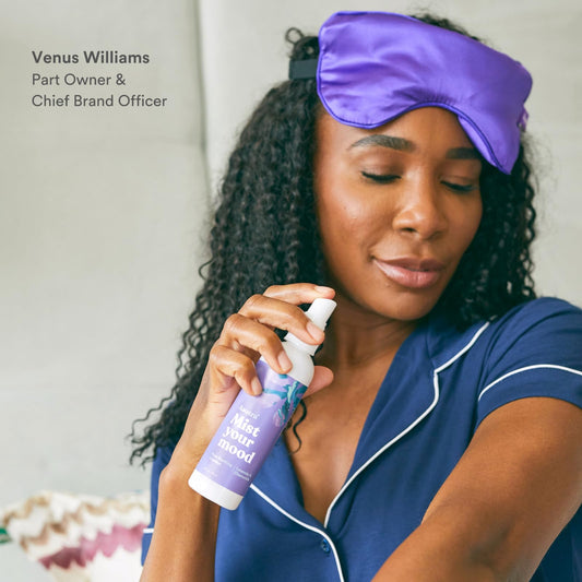 Close-up of ASUTRA Lavender Pillow Spray mist being sprayed on bed linens