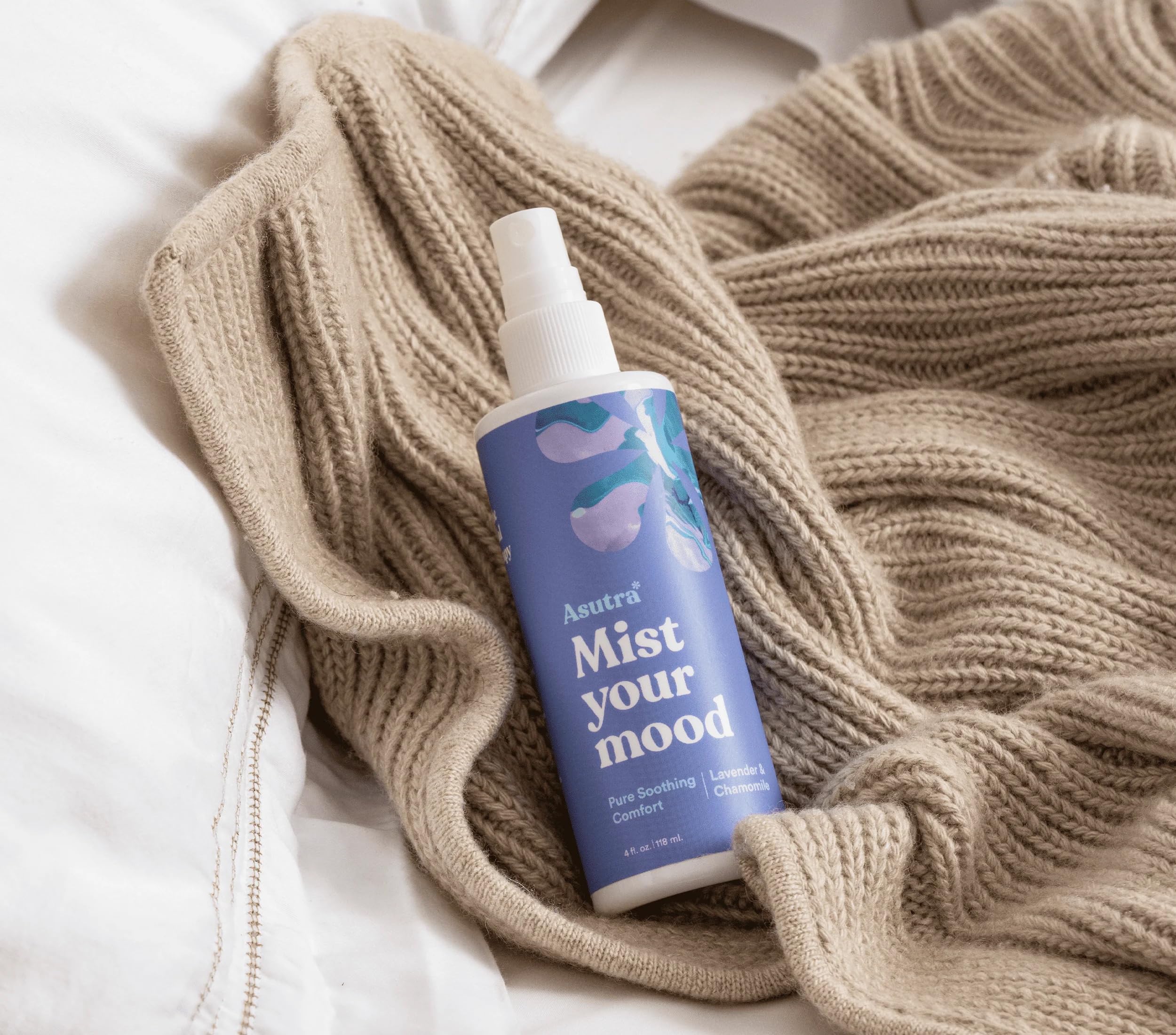 Pillow spray bottle displayed with lavender and chamomile