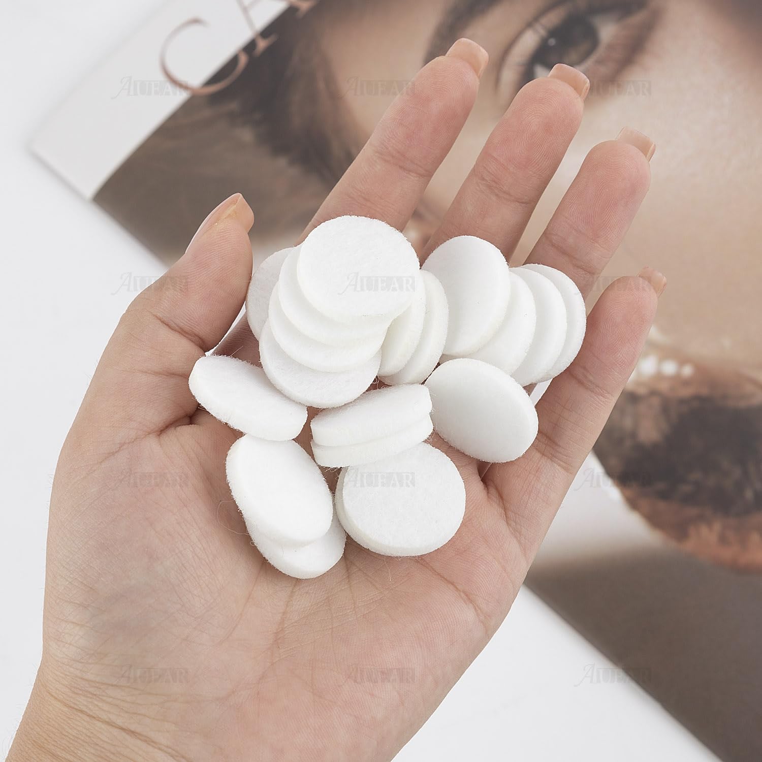 Close-up of white round mini diffuser refill pad (22mm) for diffuser jewelry