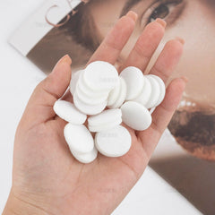 Close-up of white round mini diffuser refill pad (22mm) for diffuser jewelry