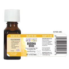 Aura Cacia Buddha Wood drops on skin for subtle daily calm.