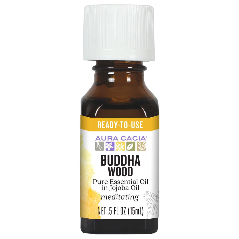 Aura Cacia Buddha Wood oil bottle closeup shows amber oil and purity.