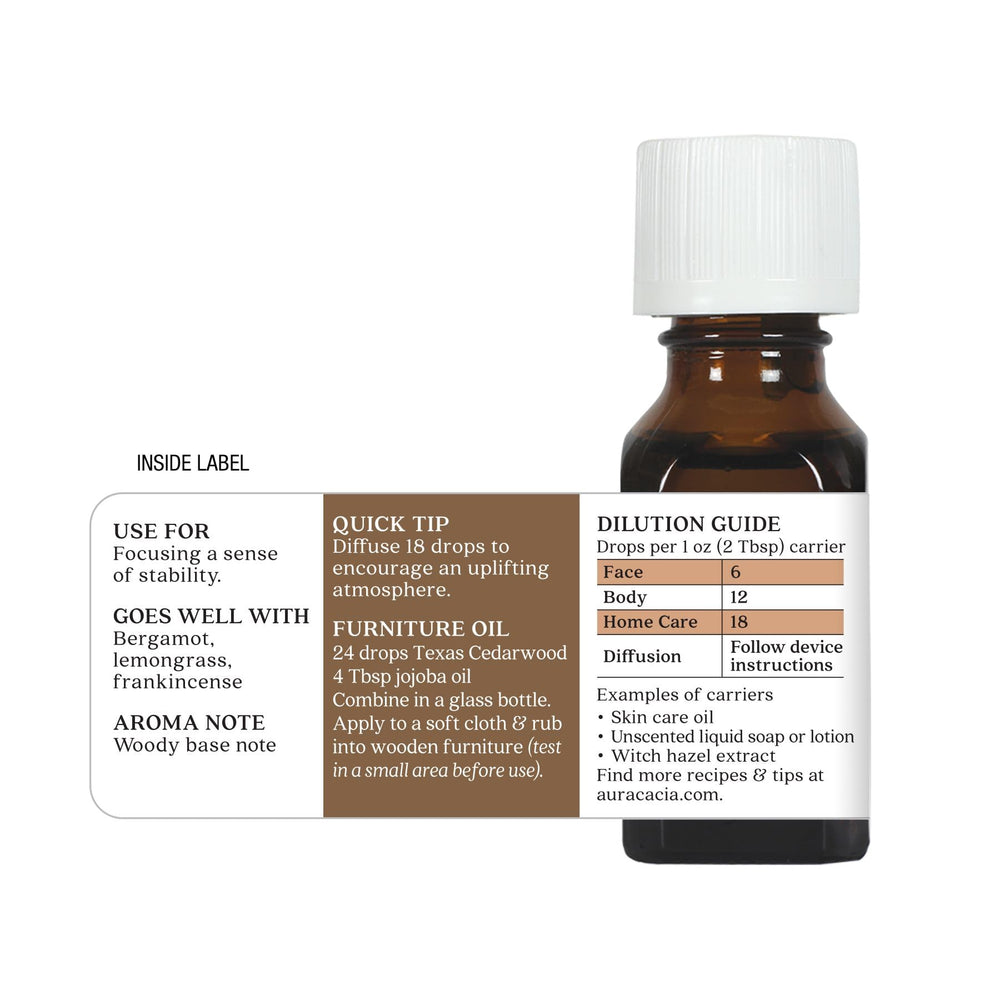 Aura Cacia Cedarwood bottle on a wooden surface