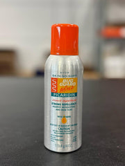 Avon Skin So Soft Bug Guard Plus Picaridin spray bottle shown outdoors for on-the-go protection.