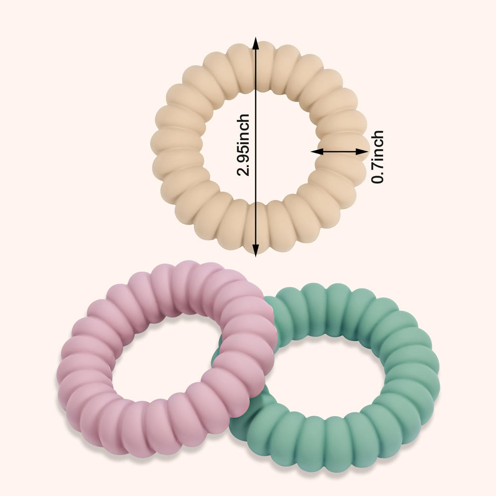 Baby holding silicone teether ring with rattle
