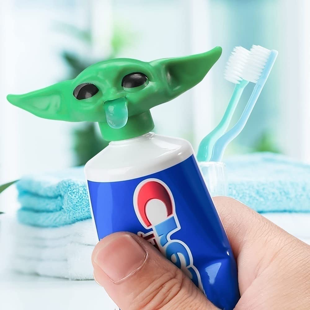 Cute Baby Yoda toothpaste cap dispenser on bathroom sink