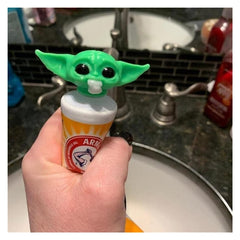 Angle view of Baby Yoda toothpaste cap topper