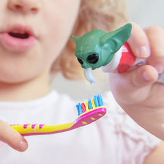 Close-up of Baby Yoda toothpaste cap with eyes and smile