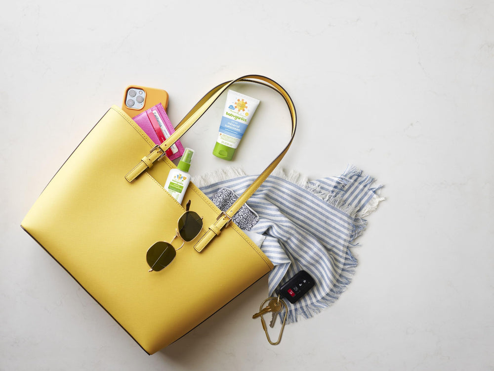 BabyGanics insect spray bottle in use, easy spray for park outings.