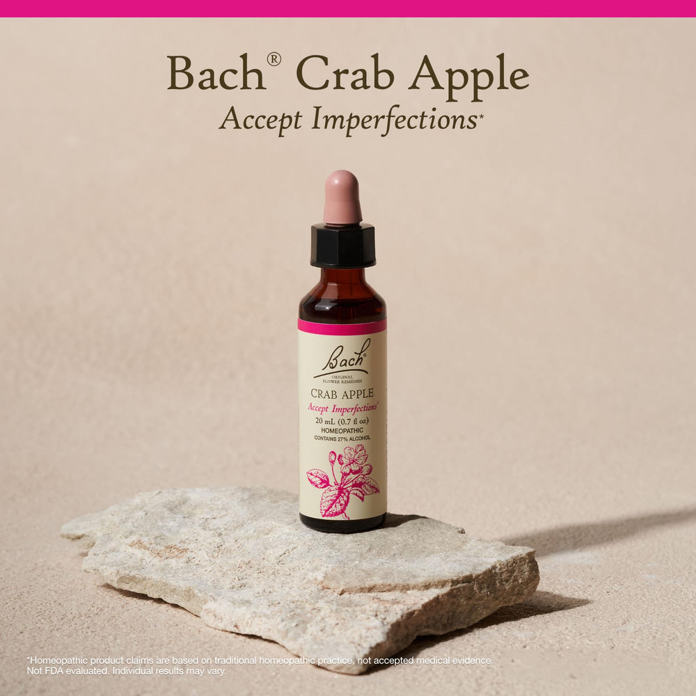 Hand holding Bach Crab Apple bottle for scale and portability, showing travel-friendly size