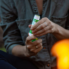 Badger Bug Repellent Stick in use at a picnic with kids and adults.