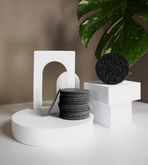 Bamboo Charcoal Cleansing Sponge closeup texture emphasizes porous surface for gentle exfoliation.