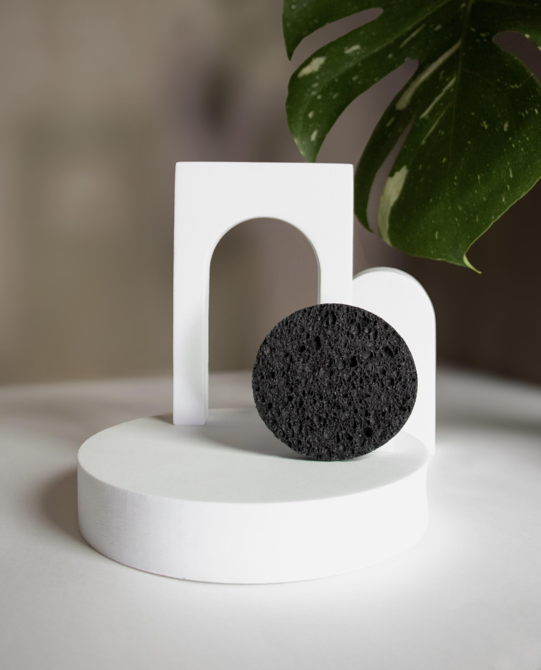 Bamboo Charcoal Cleansing Sponge in-use on face demonstrates mild cleansing and oil control.