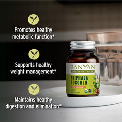 Banyan Botanicals Triphala Guggulu tablets closeup for gentle cleansing support.