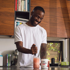 Serving scoop with powder next to a prepared drink
