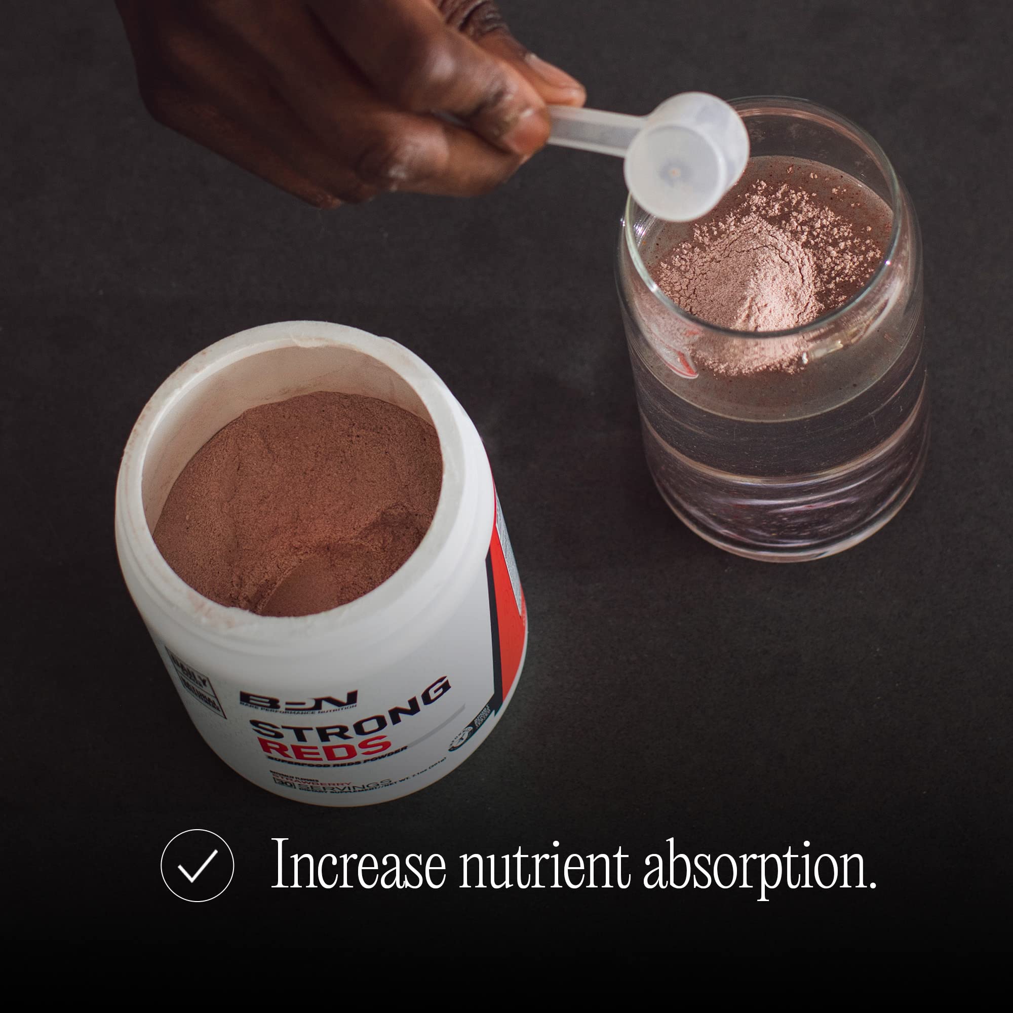 Lifestyle shot of someone mixing BPN Strong Reds into a beverage