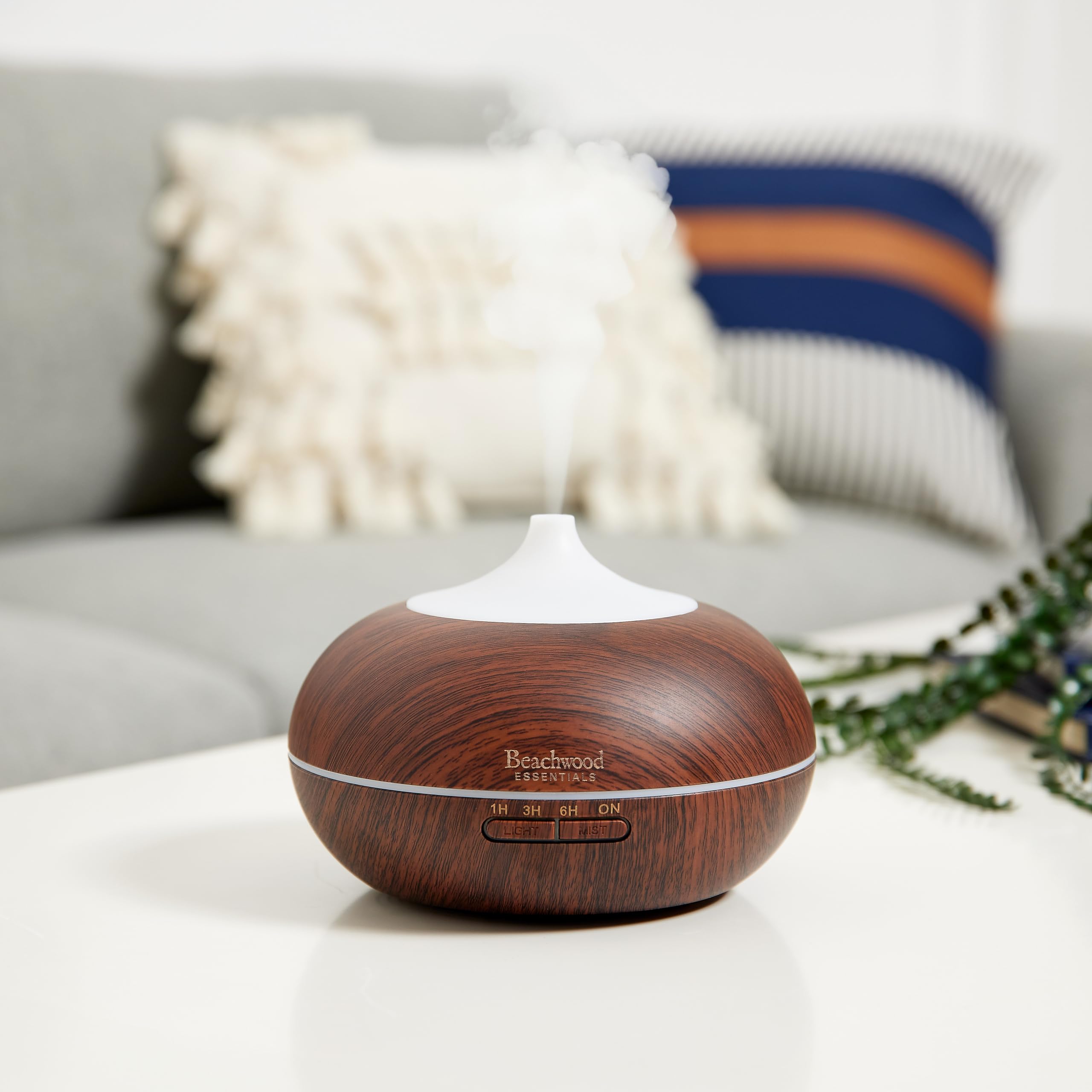 White Beachwood Essentials diffuser placed in a living room