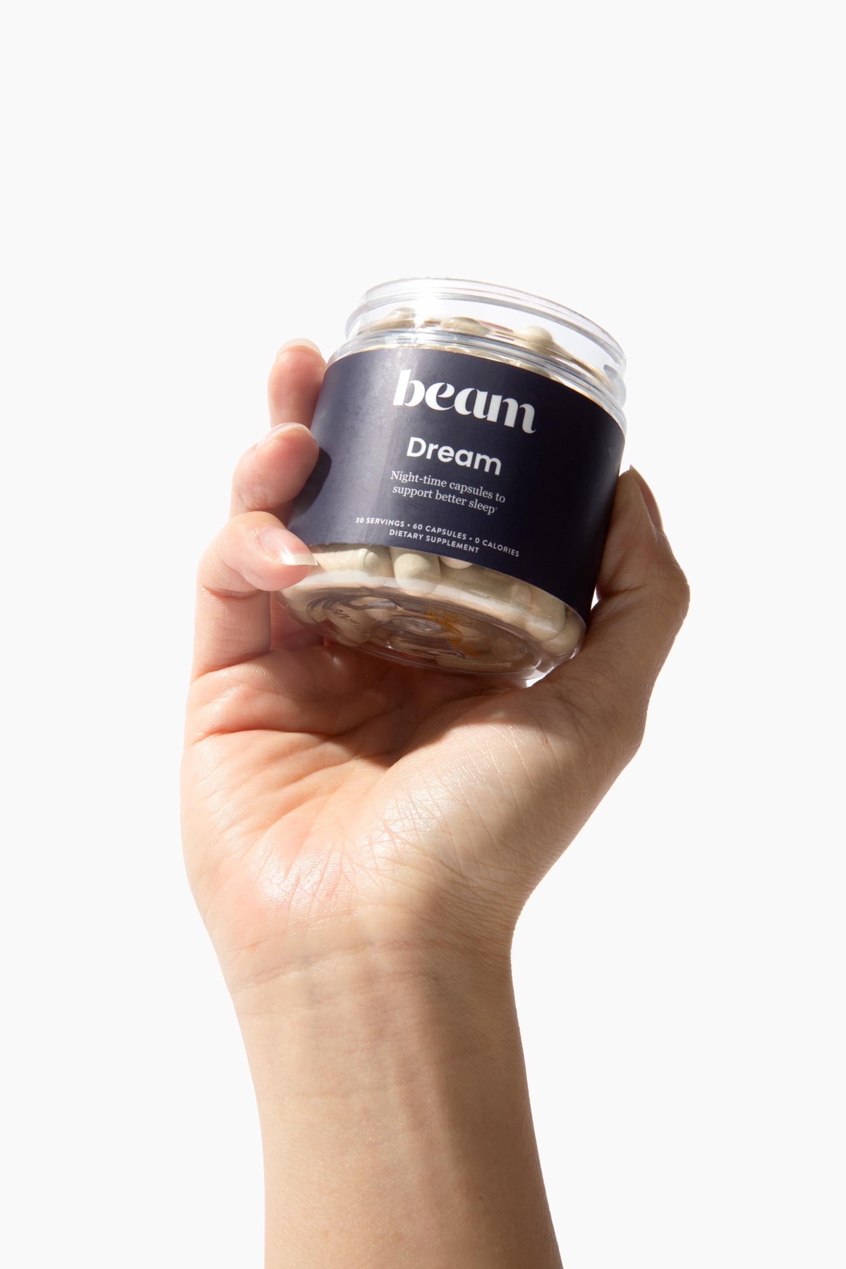 Beam Dream Sleep Capsules being poured ready for bedtime routine with water.