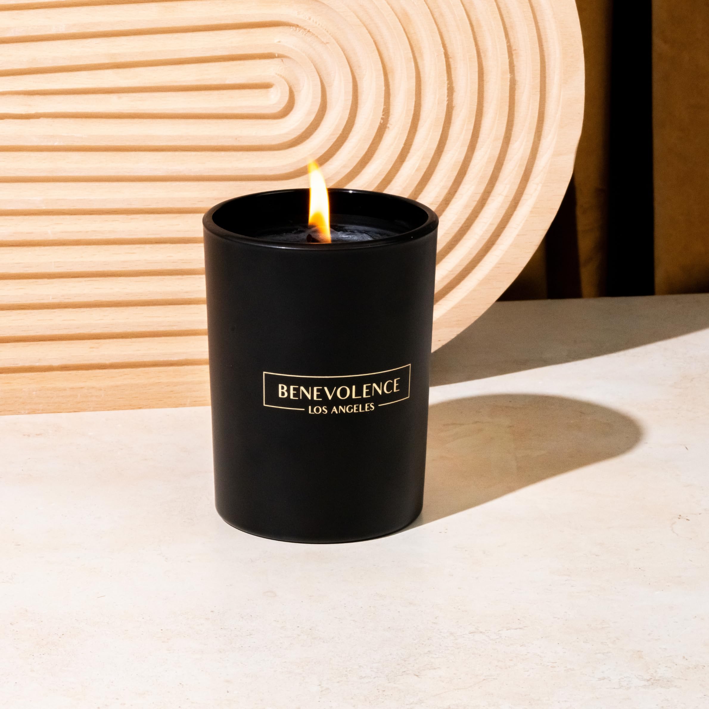 Soft glow of a black wax candle for mood lighting