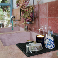 Benevolence LA Clearance Candle lit with warm glow in a cozy setting