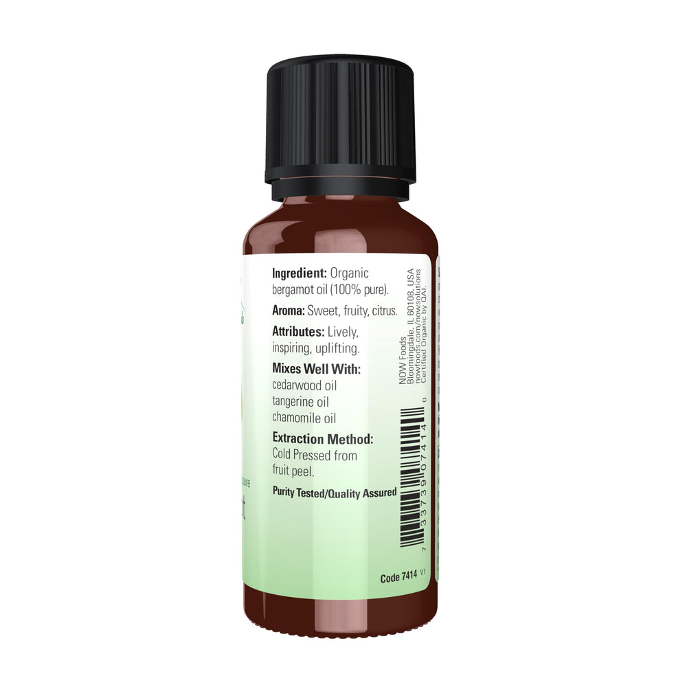 Bergamot essential oil dropper dispensing from bottle