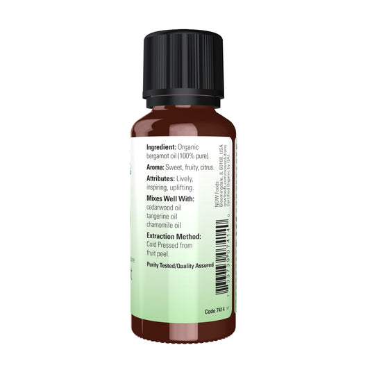 Bergamot essential oil dropper dispensing from bottle