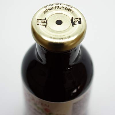 Pouring elderberry syrup into a glass